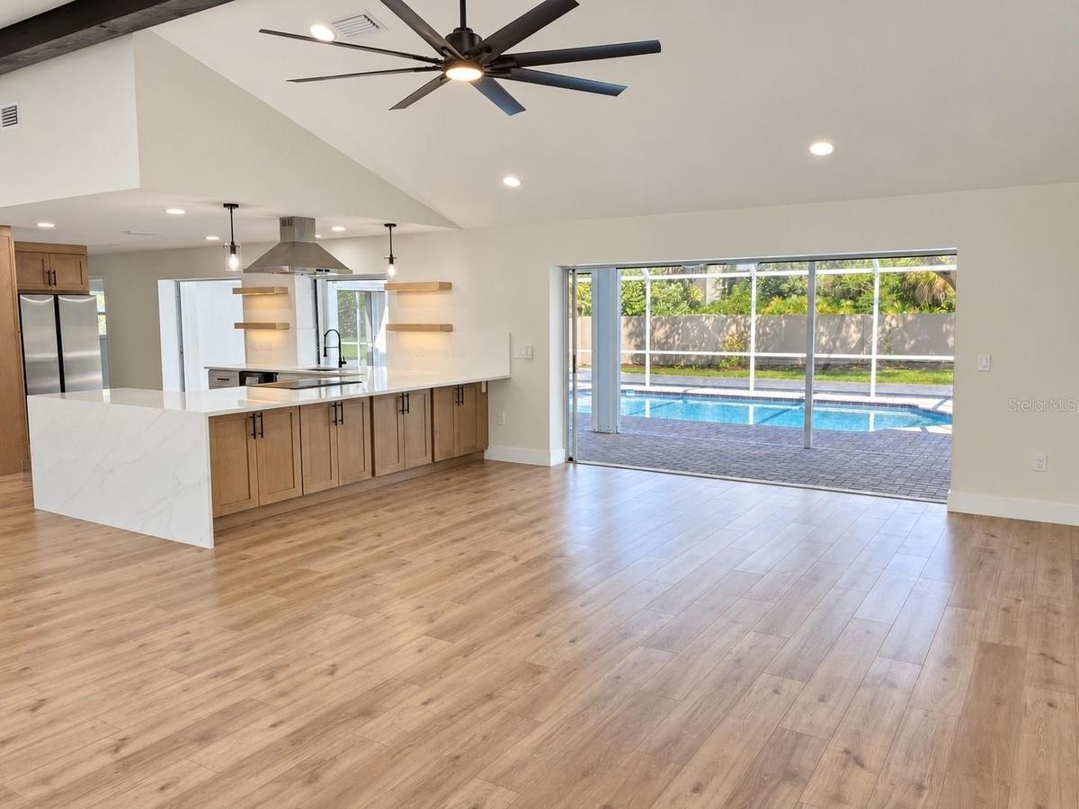 Living area with kitchen and pool access