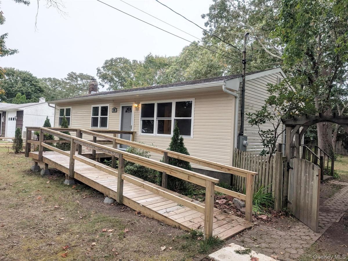 Paver walk and gate access to the side door.