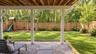 Imagine the possibilities! A beautifully landscaped, fenced-in backyard with room for play, outdoor fun, and making lasting memories. (AI-generated re