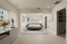 Sunlit Primary Bedroom with direct pool access.