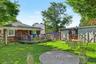 Private backyard with deck and garden beds—perfect for relaxing or entertaining.