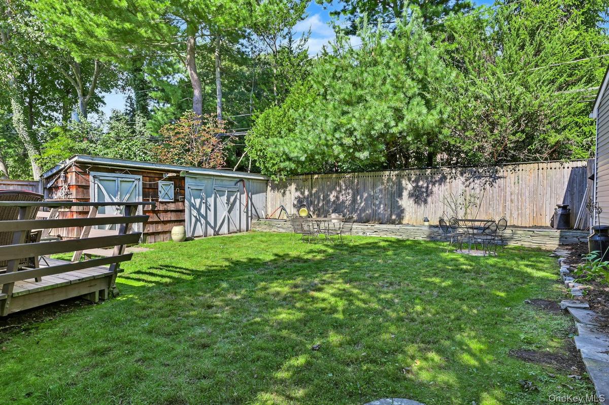 Private backyard with deck and retractable awning—perfect for relaxing or entertaining.