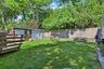 Private backyard with deck and retractable awning—perfect for relaxing or entertaining.