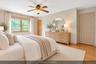 Virtually Staged Primary Bedroom With En-suite Bath and Walk-In Closet