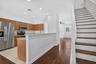 Kitchen featuring stainless steel appliances, wood-finish cabinetry, and recessed lighting