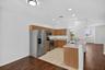 Kitchen featuring wood-finish cabinetry, stainless steel appliances, and light-toned countertops