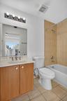 Wood-finish vanity with a light-colored countertop and integrated sink