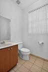 Wood-finish vanity with an integrated sink and chrome faucet