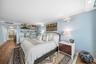 Wood-finish flooring throughout, built-in shelving, and recessed lighting