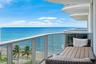 Balcony with glass panel railing and ocean backdrop
