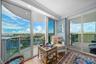 Expansive water scenery, floor-to-ceiling glass doors, recessed lighting, wood-finish flooring, and crown molding