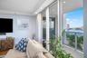 Sliding glass doors opening to a balcony with glass railings