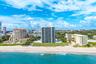 Beachfront property featuring a sandy shoreline and ocean waves