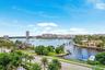 Waterfront setting with multiple docks and established palm trees