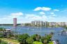 Waterfront scenery featuring a river, multiple buildings, and boats