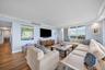 Wood-finish flooring throughout, light blue walls, and white crown molding