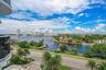 Expansive water frontage with multiple docking facilities, surrounded by mature palm trees and lush landscaping