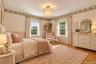 We've embraced the pink and wallpaper and wrapped it up with a modern light fixture and furnishings in this virtually imagined and comfortable room.