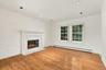 The centerpiece of the room is the hearth/mantle and a wood burning fireplace.