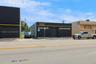 Central drive between two buildings allow access to paved parking in rear.