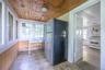 Wood-finish plank ceiling and walls, multiple pane windows, and a tiled floor