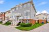 Multi-level townhouse with brick and siding exterior, and dedicated entryways