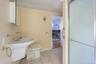 Pedestal sink, ceramic tile flooring, wall-mounted medicine cabinet, and a shower enclosure with frosted glass