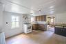 Kitchen area featuring wood-finish cabinetry, a gas range, and a window above the sink