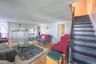 Hardwood-finish flooring, white paneled walls, and a built-in decorative mantel