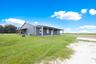 Side view of the home set back on open land
