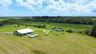 Aerial view of the home, pool and guest unit surrounded by open land