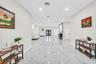 Open-concept living area with large-format tile and recessed lighting