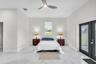 Primary suite with ceiling fan and French doors