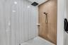 Walk-in shower with wood-look tile accent wall