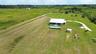 Aerial view of the home on nearly 10 acres with pool, guest unit and open land