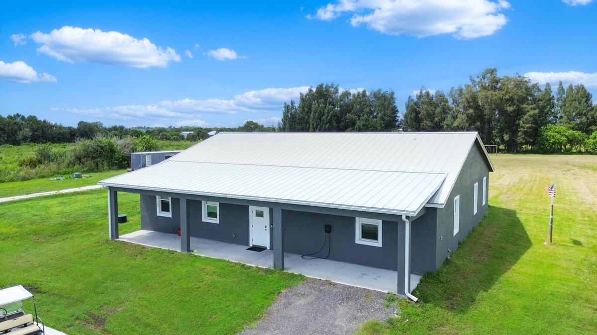 Front of the home with metal roof and covered front porch