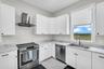 Kitchen with stainless range, dishwasher and window over the sink