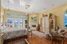 Primary Suite with Harwood Floors, Fireplace, Crown Molding and French Doors to the Balcony