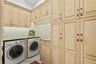 Laundry Room with sink and plenty of custom storage cabinets for cleaning supplies and paper goods.