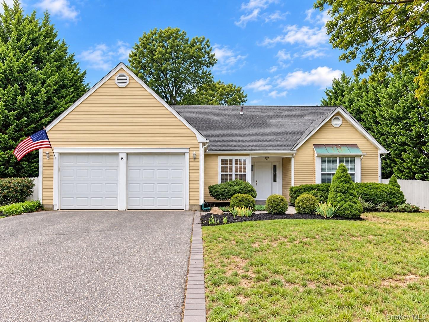 Yellow siding exterior with a dark shingle roof