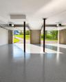Expansive garage with a speckled epoxy floor finish and white painted walls