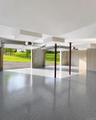 Spacious garage featuring a speckled epoxy floor finish and concrete walls
