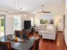 Living Room/Dining Room Vaulted ceilings complement the warm wood-finish flooring