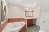 Ensuite bathroom with hot tub and shower