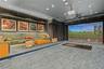 Media room featuring tiered flooring, custom upholstered wall panels, recessed lighting, and a built-in projection system with a golf simulator screen