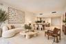 Open-concept interior featuring light-toned stone flooring, high ceilings with recessed lighting, and a modern kitchen with cabinetry and a center isl