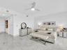 Wake up to breathtaking ocean views from the comfort of your bed in this spacious primary suite, featuring floor-to-ceiling sliding glass doors with d
