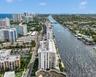 Aerial perspective of coastal landscape featuring deep-water waterway access, proximity to oceanfront high-rises, and established waterfront urban inf