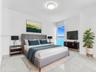 Bright and airy interior featuring soaring ceilings, dramatic floor-to-ceiling windows that fill the space with natural light, elegant hard-surface fl