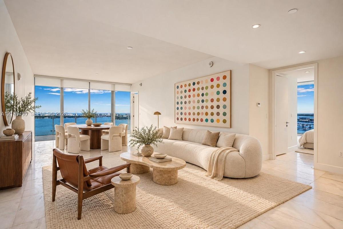 Floor-to-ceiling glass walls, stone flooring, and recessed ceiling lighting